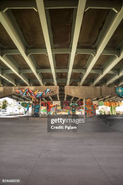 graffiti on a downtown highway underpass - underpass stock pictures, royalty-free photos & images