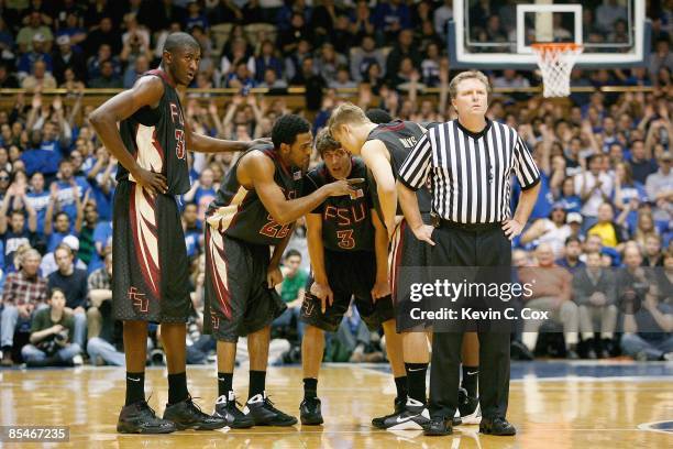 Solomon Alabi, Derwin Kitchen, Luke Loucks and Deividas Dulkys of the Florida State Seminoles meet on court against the Duke Blue Devils during the...