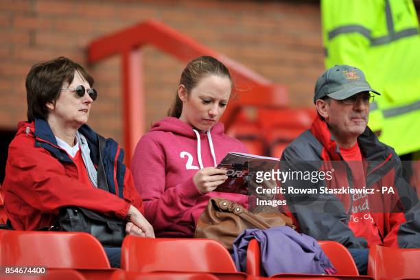 Nottingham Forest fan reads the match day programme prior to kick off