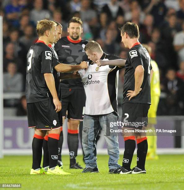 Fan invades the pitch during the match to get autographs during the pre-season friendly at the AJ Bell Stadium, Salford.