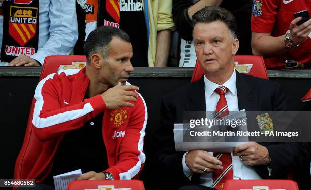 Manchester United manager Louis van Gaal takes his seat next to his assistant Ryan Giggs, during a pre season friendly at Old Trafford, Manchester.