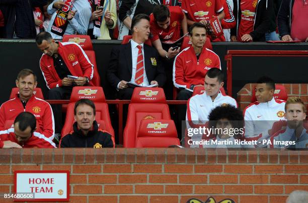 Manchester United manager Louis van Gaal takes his seat next to his assistant Ryan Giggs, during a pre season friendly at Old Trafford, Manchester.