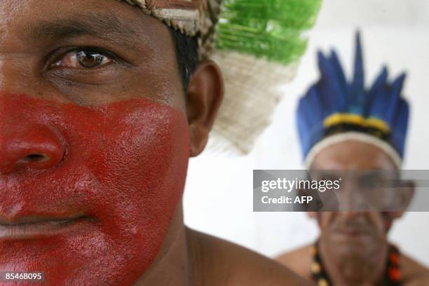 Brazilian natives from the Makunaimi tribe take part in a demonstration outside the Supreme Federal Court on March 17, 2009 in Brasilia, on the eve...