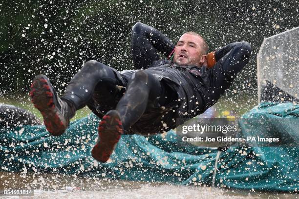 Competitor takes part in Tough Mudder South West at Cirencester Park, Cirencester.