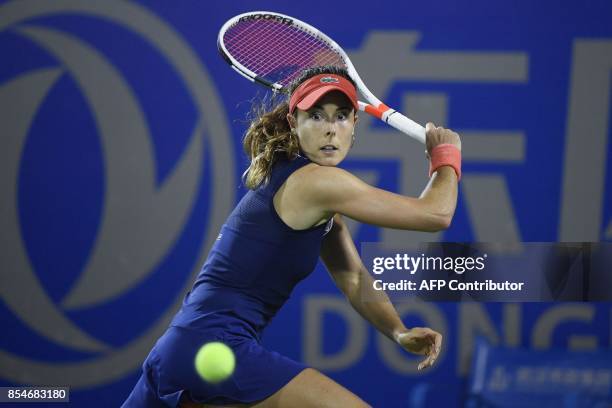 Alize Cornet of France hits a return against Varvara Lepchenko of the US during their third round women's singles match at the WTA Wuhan Open tennis...