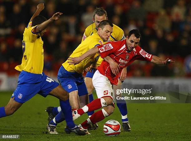 Michael Mifsud of Barnsley battles with Shaun Derry,Clint Hill and James Comley of Crystal Palace during the Coca-Cola Championship match between...