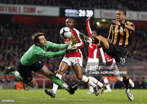 Hull City's Brazilian player Geovanni attempts a shot at goal as Arsenal's Polish goalkeeper Lukasz Fabianski dives for the ball during the F.A Cup...