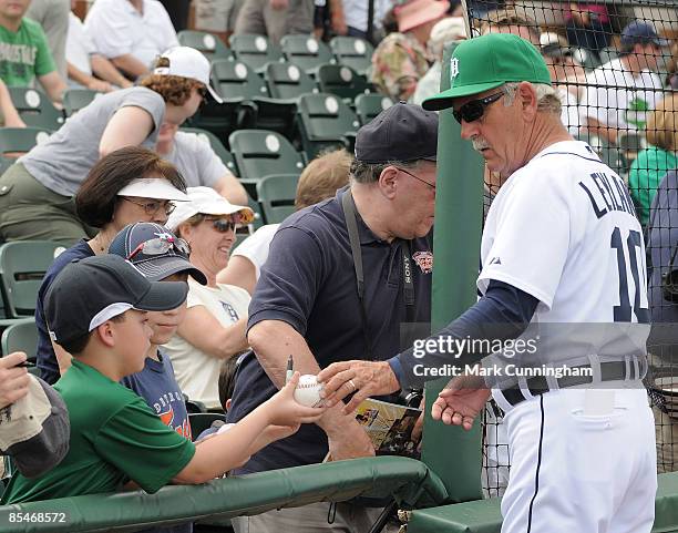 Manager Jim Leyland of the Detroit Tigers signs autographs while wearing a green hat for St. Patricks Day before the spring training game against the...