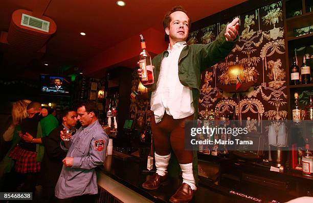 Worker calls out for shots at a bar after the 248th annual St. Patrick's Day parade March 17, 2009 in New York City. The parade honors the patron...