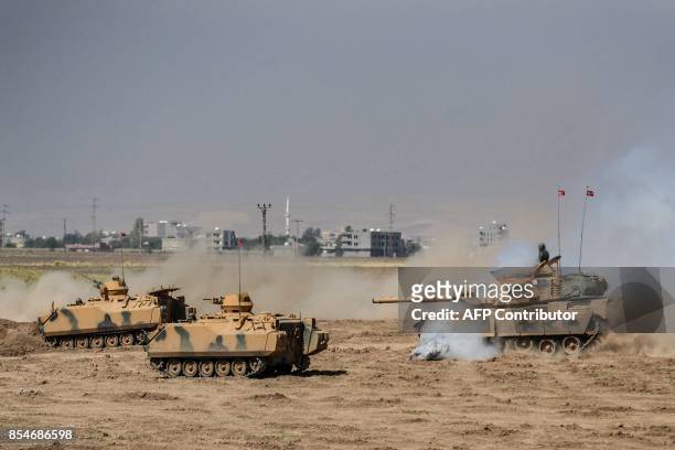 Turkish soldier ride armoured vehicles near the Habur crossing gate between Turkey and Iraq during a military drill on September 27, 2017 in the...