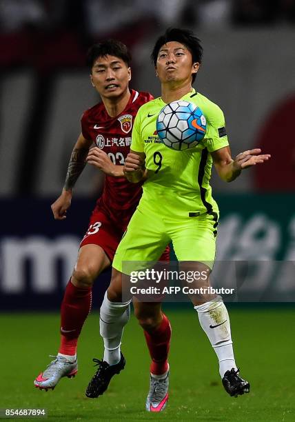 Urawa' Muto Yuki takes the ball during the AFC Champions League semi-final football match between Shanghai SIPG FC and Urawa Red Diamonds in Shanghai...