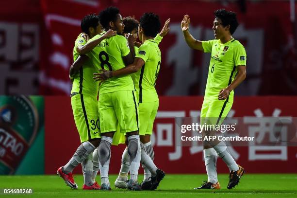 Urawa' players celebrate the goal during the AFC Champions League semi-final football match between Shanghai SIPG FC and Urawa Red Diamonds in...