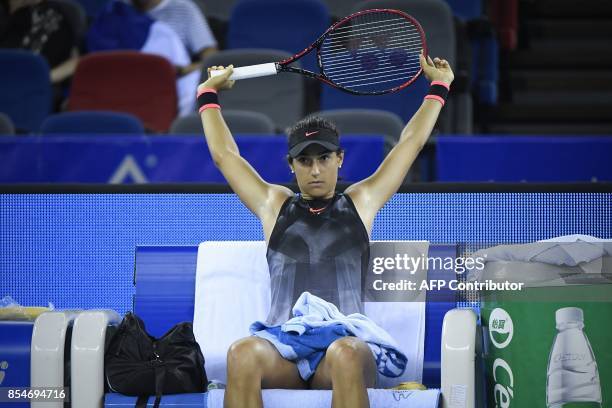 Caroline Garcia of France takes a rest in the third round women's singles match against Dominika Cibulkova of Slovakia at the WTA Wuhan Open tennis...