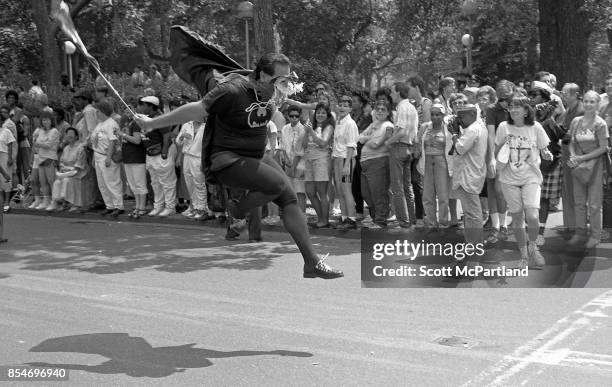 Man dressed as Batman enthusiastically jumps into the air in celebration, at the 1989 Gay Pride Parade in Greenwich Village, Manhattan commemorating...