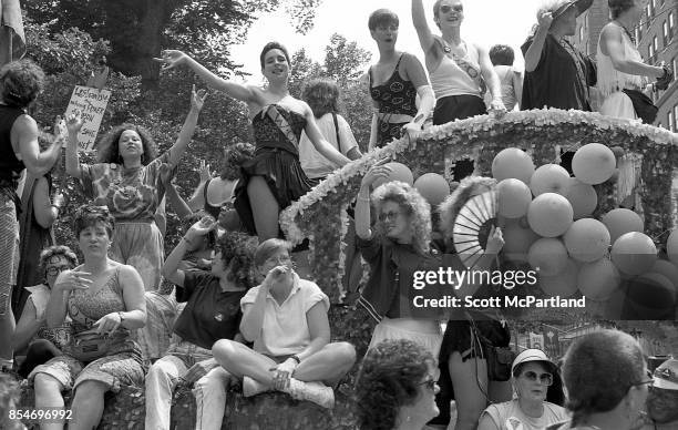 Crowded parade float full of smiling and laughing gay rights activists wave to the crowd during the 1989 Gay Pride Parade in Greenwich Village,...