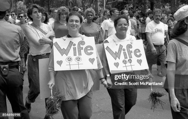 Two women wearing "Wife" signs around their necks, smile for the camera, at the 1989 Gay Pride Parade in Greenwich Village, Manhattan commemorating...