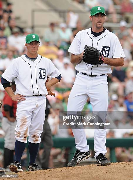 Brandon Inge and Justin Verlander of the Detroit Tigers look on while wearing green hats in honor of St. Patrick's Day during the spring training...