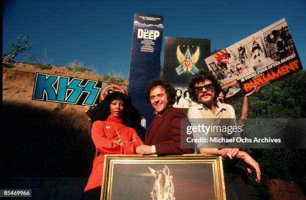 Queen of Disco" Donna Summer poses for a portrait in front of posters promoting various thing including the rock and roll band "Kiss", the movie "The...