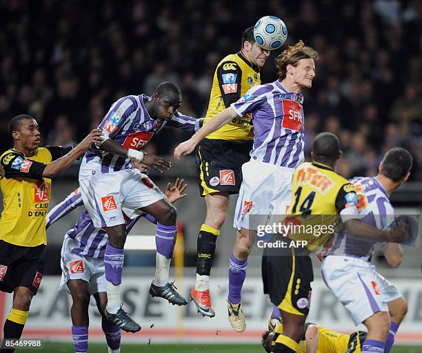 Lille's defender Rami Adil fights for the ball against Toulouse's Cetto Mauro, Toulouse's Moussa Sissoko during their French cup quater-final...