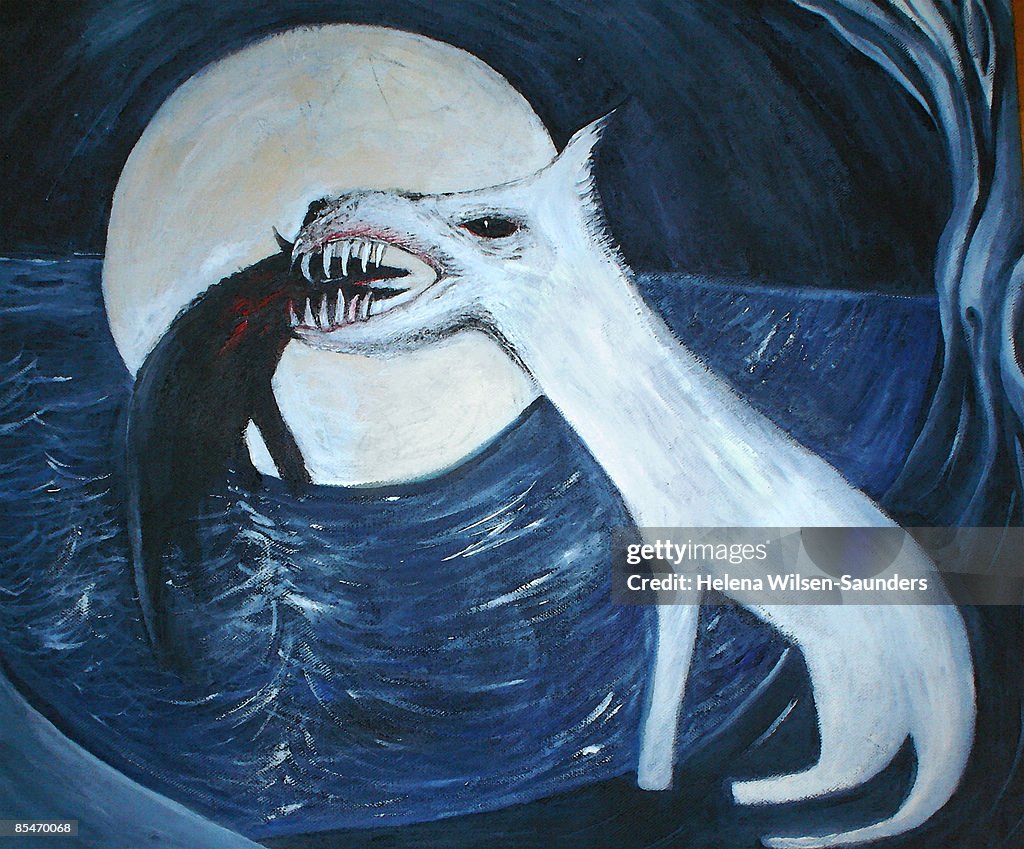 A dog eating another dog by the lake at night