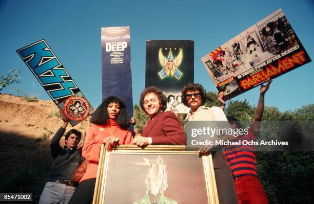 Queen of Disco" Donna Summer poses for a portrait in front of posters promoting various things, including the rock and roll band "Kiss", the movie...