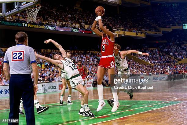 George Gervin of the Chicago Bulls shoots against Jerry Sichting of the Boston Celtics during Game One of the Eastern Conference Quarterfinals played...