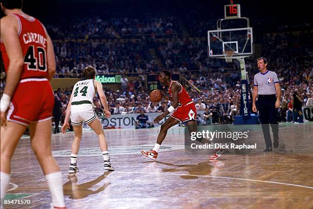 Michael Jordan of the Chicago Bulls moves the ball up court against Danny Ainge of the Boston Celtics during Game One of the Eastern Conference...