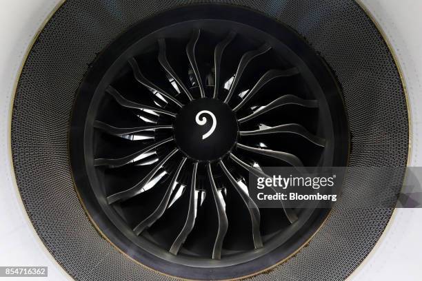 An engine of the new Airbus SE A320 Neo passenger aircraft hangs from the wing during the annual EasyJet Plc innovation day at London Gatwick airport...
