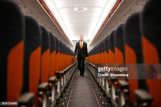 Member of EasyJet Plc cabin crew walks along the aisle of an Airbus SE A320 Neo passenger aircraft during the airlines annual innovation day at...