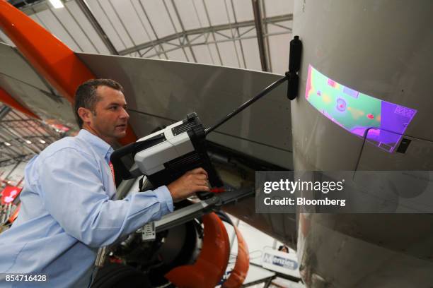Representative demonstrates a dentCHECK dent mapping tool, manufactured by 8tree, on an Airbus A320 Neo passenger aircraft during the annual EasyJet...