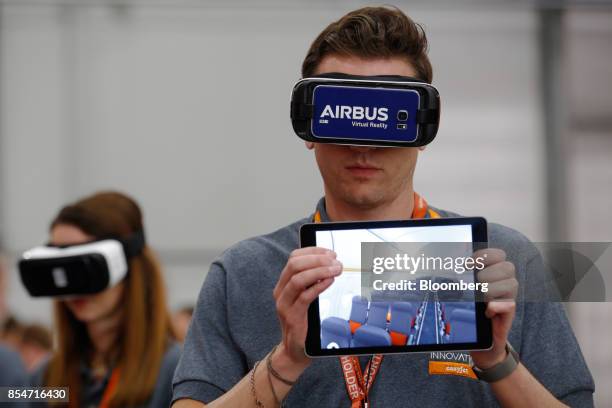 Representatives demonstrates the Airbus SE Virtual Reality headset during the annual EasyJet Plc innovation day at London Gatwick airport in Crawley,...