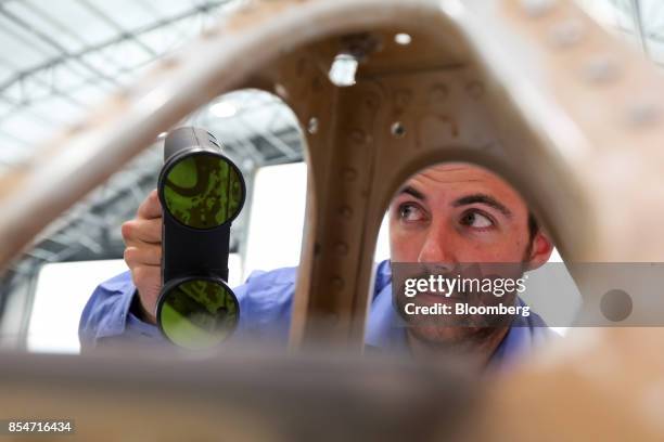 Robert Wells, applications engineer at OR3D Ltd., demonstrates a Mantis Vision F5B-SR 3D imager on an aircraft nose cone part during the EasyJet Plc...