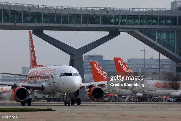 Passenger aircraft operated by EasyJet Plc taxis past other aircraft at London Gatwick airport in Crawley, U.K., on Wednesday, Sept. 27, 2017....