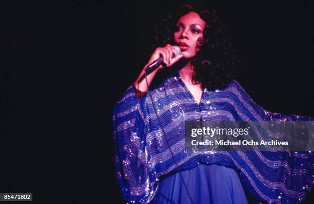 'Queen of Disco' Donna Summer performs onstage in a shimmering blue dress in circa 1979.