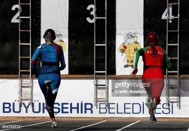 Firefighters run to climb ladders during the 13th World Championship among men and VI World Championship among women in fire and rescue sports with...