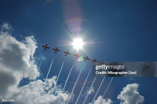 jets flying in sky leaving smoke trail, low angle view - canadian snowbird 個照片及圖片檔