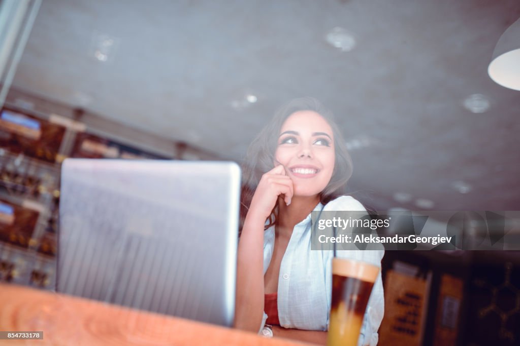 Smiling Female Freelancer Working in her Favorite Cafe in Morning