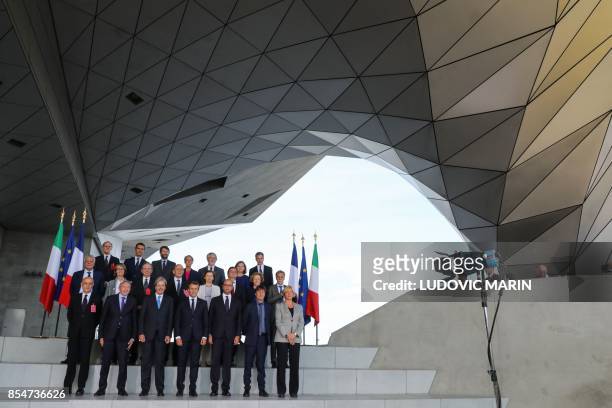 French President Emmanuel Macron , Italian Prime Minister Paolo Gentiloni , French Interior Minister Gerard Collomb , Italian Interior Minister Marco...