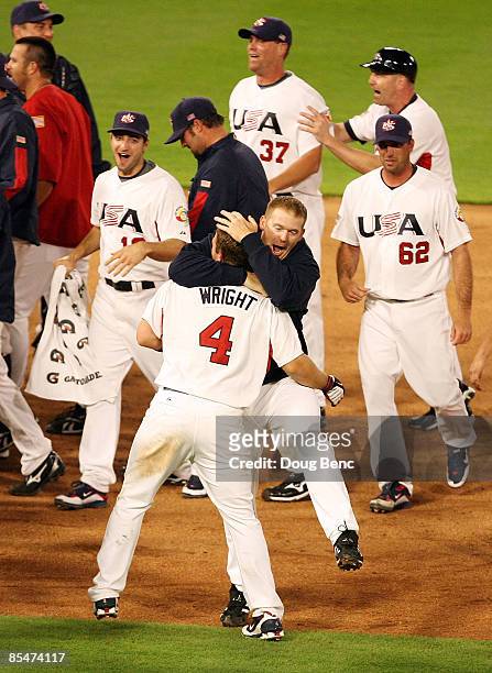 Teammates mob David Wright of the United States as they celebrate their victory over Puerto Rico during day 4 of round 2 of the World Baseball...