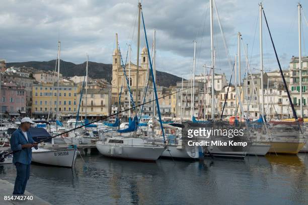 Evening view of a fisherman over the marina in the port on 16th September 2017 in Bastia, Corsica, France. Bastia is a French commune in the...