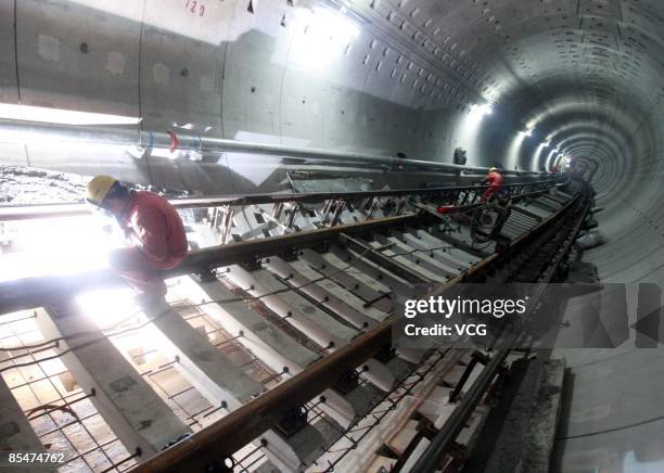 Workers install rails in the tunnel of Metro Line 7 on March 17, 2009 in Shanghai, China. Contruction on Line 7, which will run past the 2010 World...