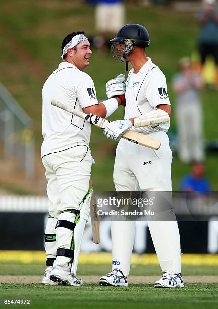 Jesse Ryder of New Zealand is congratulated by teammate Chris Martin after he scored his first test century during day one of the First Test match...