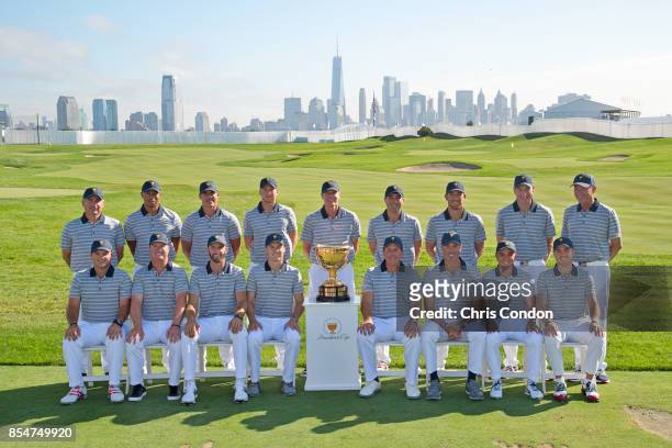 The U.S. Team poses for a group photo with the Presidents Cup trophy prior to the start of the Presidents Cup at Liberty National Golf Club on...