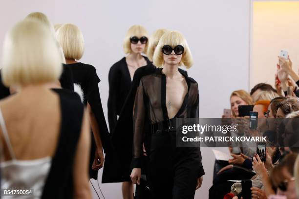 Models present creations by Guy Laroche, during the women's 2018 Spring/Summer ready-to-wear collection fashion show in Paris, on September 27, 2017....