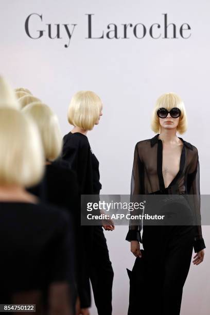 Models present creations by Guy Laroche, during the women's 2018 Spring/Summer ready-to-wear collection fashion show in Paris, on September 27, 2017....