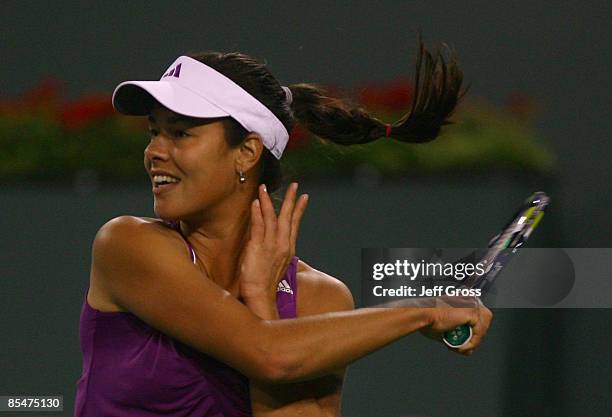 Ana Ivanovic of Serbia returns a forehand to Flavia Pennetta during the BNP Paribas Open at the Indian Wells Tennis Garden on March 17, 2009 in...