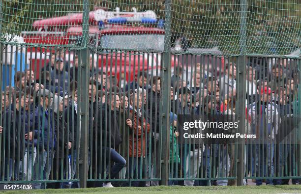 Fans watch through a fence during the UEFA Youth League match between CSKA Moskva U19s and Manchester United U19s at Oktyabr Stadium on September 27,...