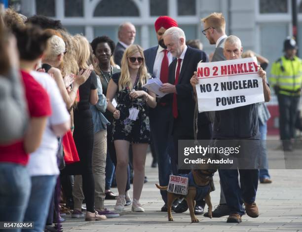 Protester with a banner reading "No To Hinkley No To Nuclear Power" gets in the way at the arrival of Labour Party leader Jeremy Corbyn ahead...