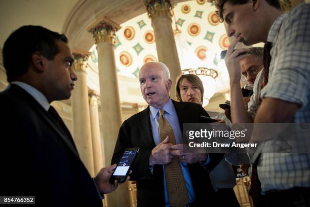 Sen. John McCain talks with reporters on his way to a meeting with Republican Senators, September 27, 2017 in Washington, DC. On Wednesday,...