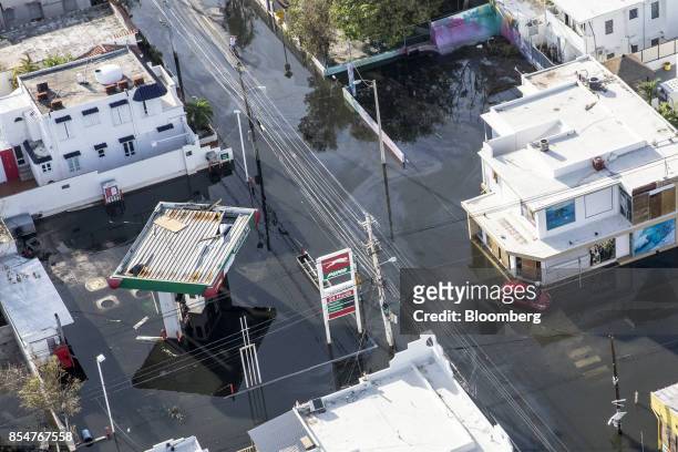 Vehicle passes in front of a gas station filled with floodwater from Hurricane Maria in this aerial photograph taken above Barrio Obrero in San Juan,...